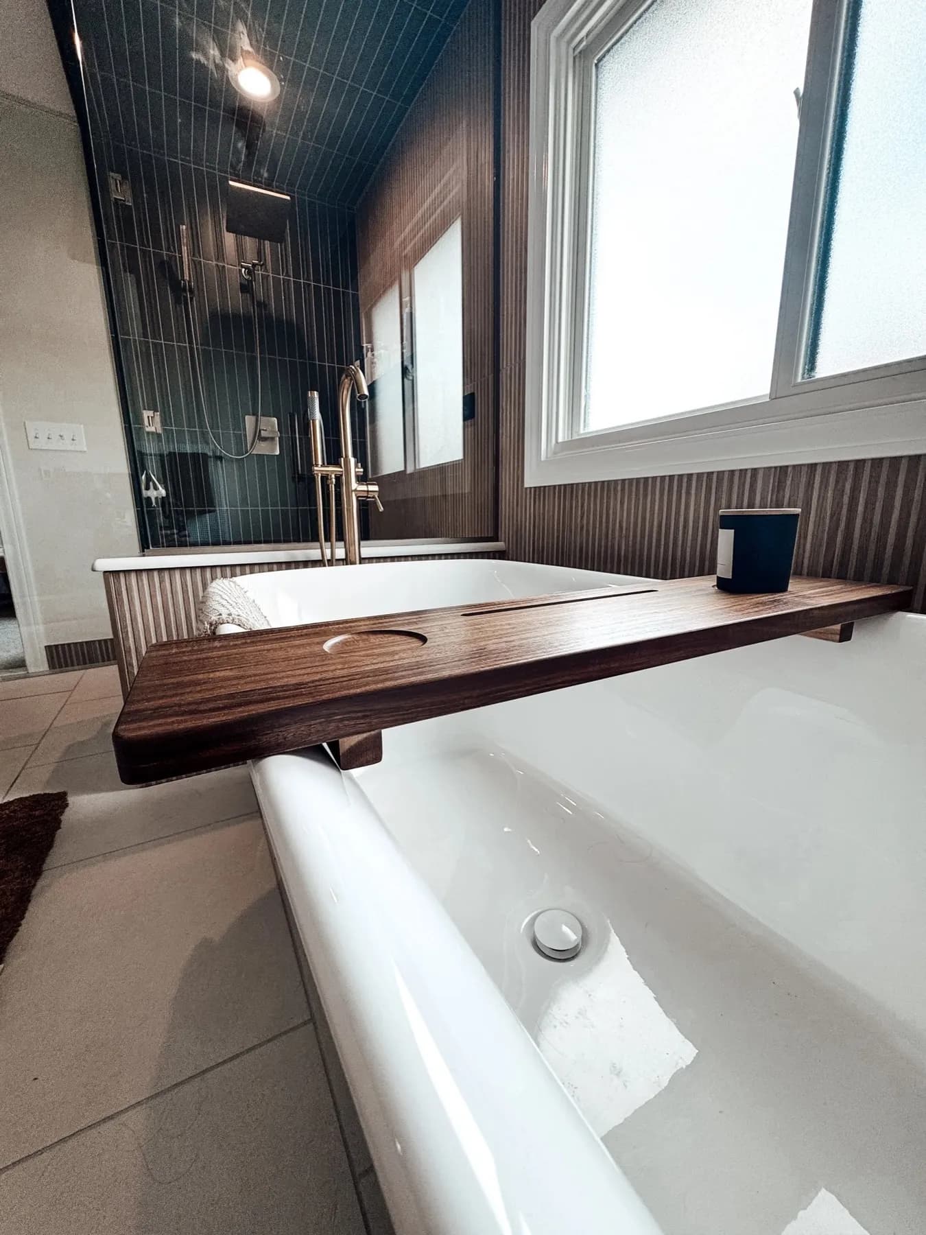 Soaking tub with a wood shelf and a vertical slat wall detail